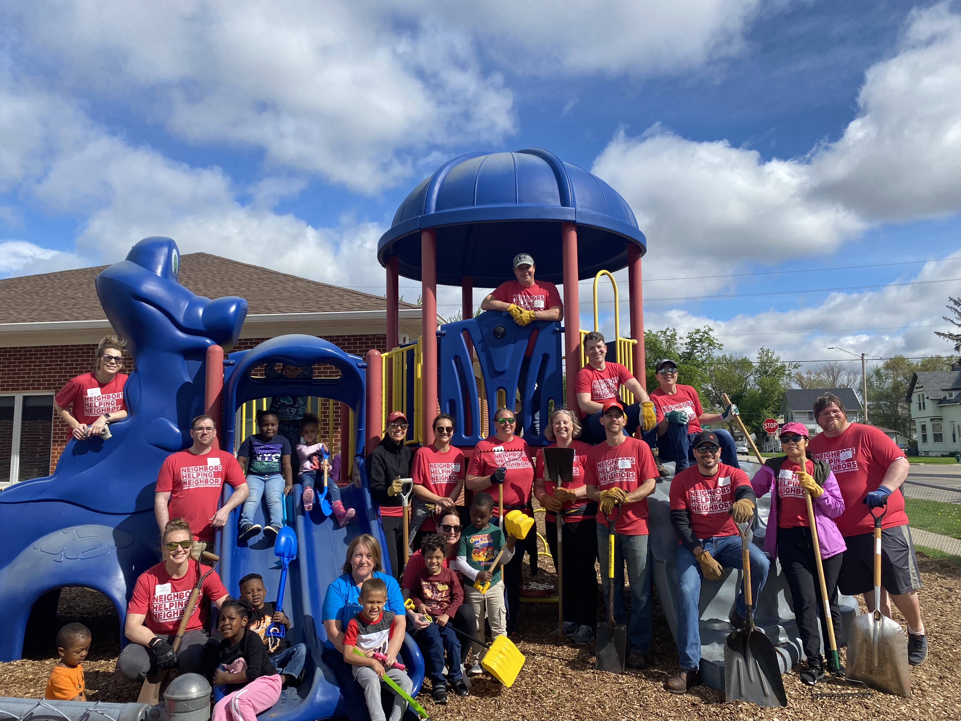 A group of volunteers give thumbs up