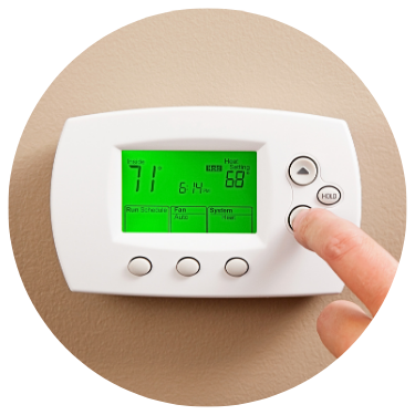 Woman Adjusting Thermostat