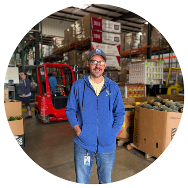 Man Stands in Warehouse